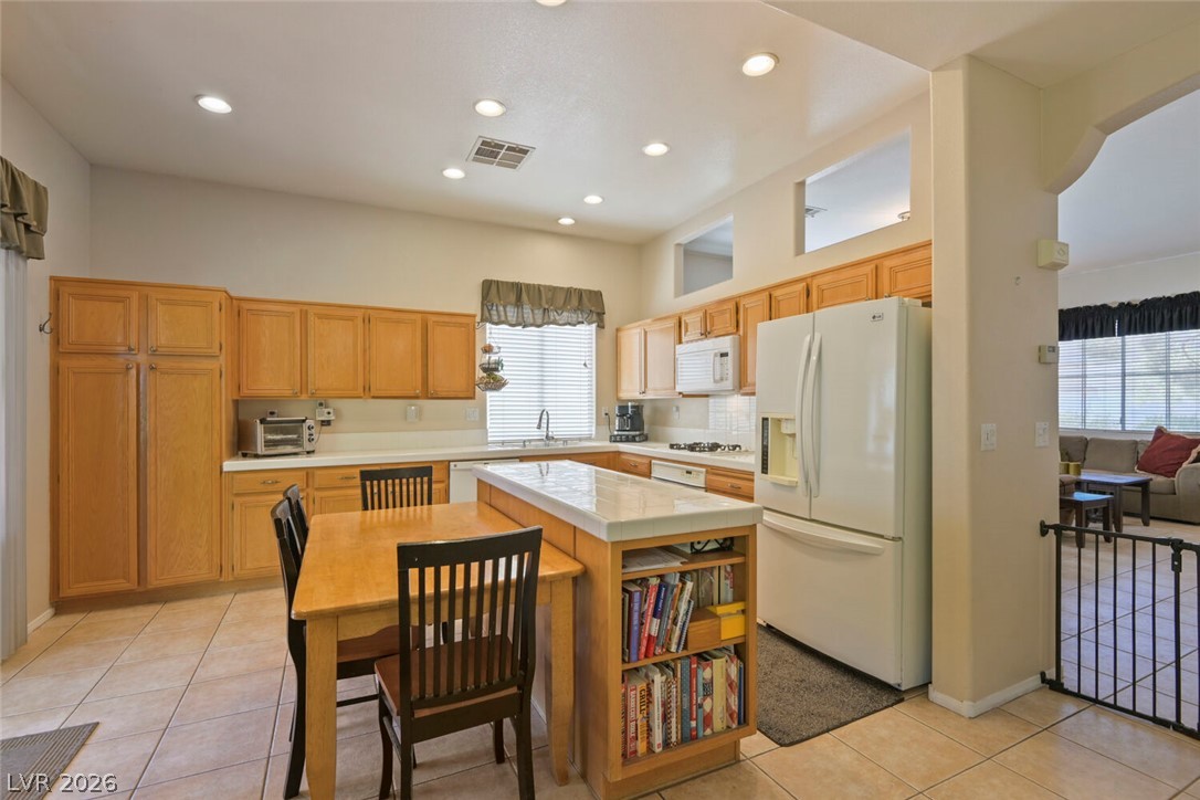 2356 Tilden Way Henderson, NV 89074 - Photo 11 of 30 Bright and functional, this kitchen features warm wood cabinetry and a convenient central island.