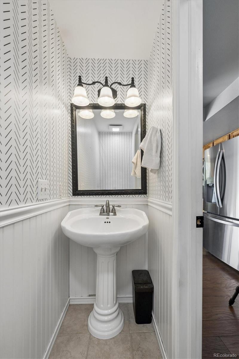 10433 Garrison Street Broomfield, CO 80021 - Photo 11 of 30 a bathroom with a sink and a mirror