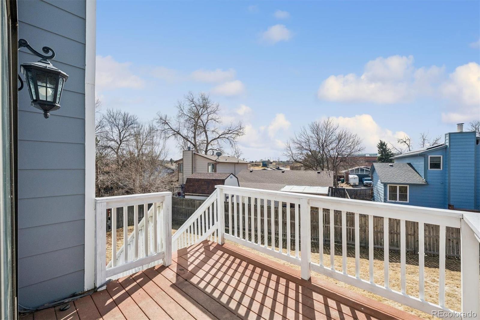 10433 Garrison Street Broomfield, CO 80021 - Photo 19 of 30 a view of a balcony with wooden fence