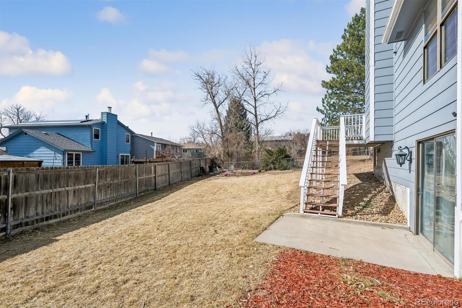 10433 Garrison Street Broomfield, CO 80021 - Photo 20 of 30 a view of a backyard with wooden fence