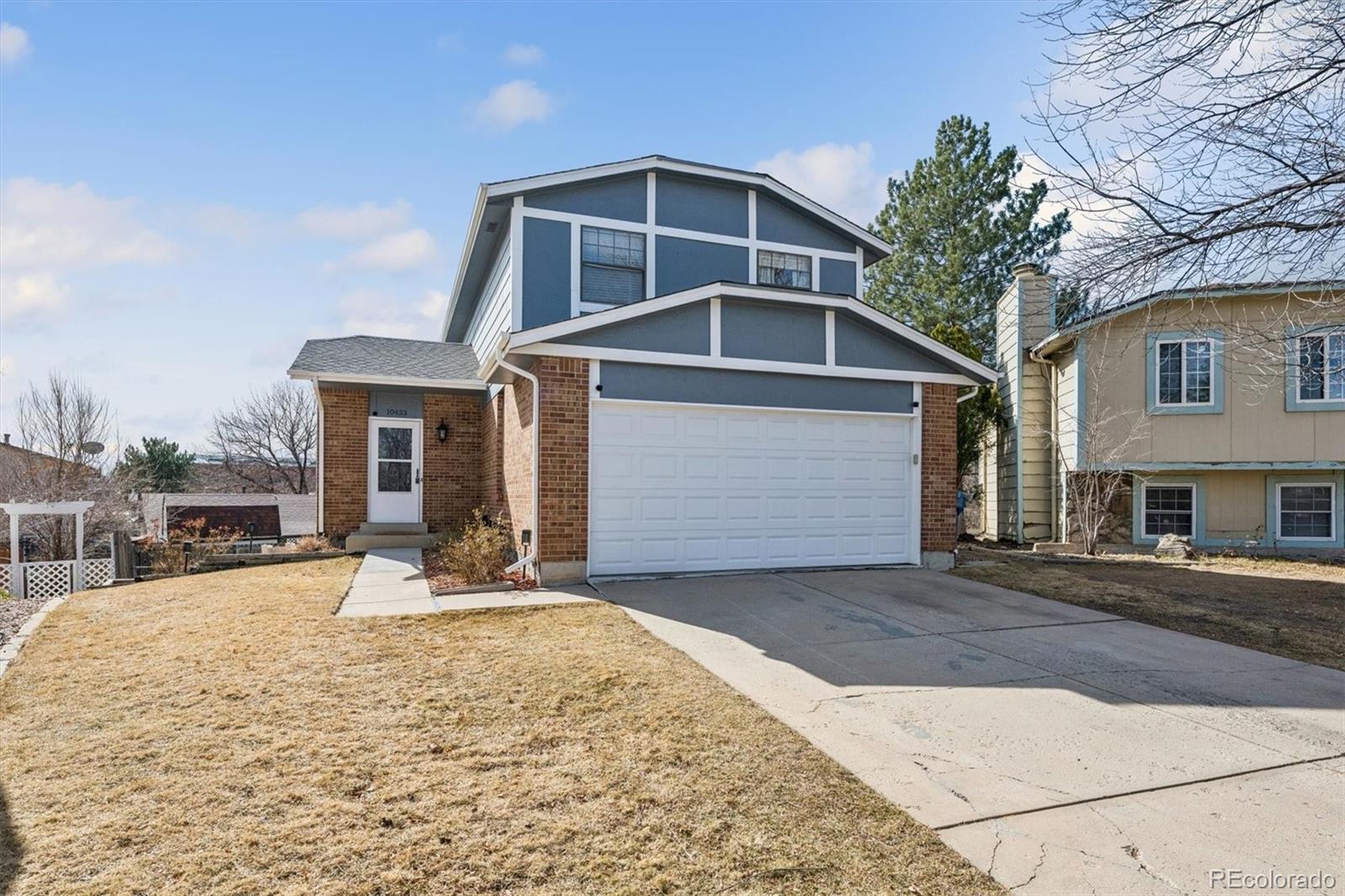 10433 Garrison Street Broomfield, CO 80021 - Photo 2 of 30 a front view of a house with a yard