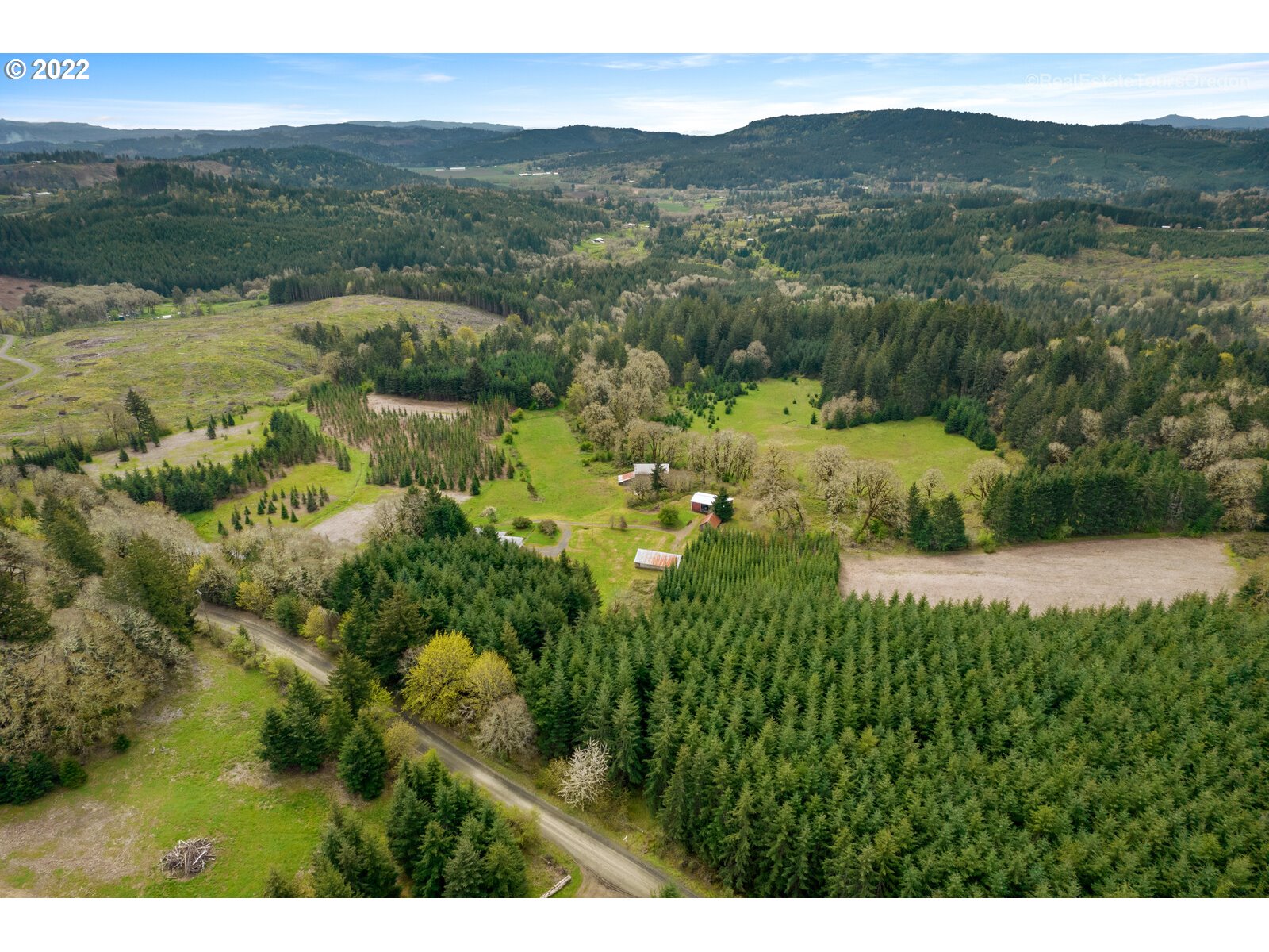 54795 Southwest Roberts School Road Gaston, OR 97119 - Photo 30 of 32 a view of a lush green hillside and houses