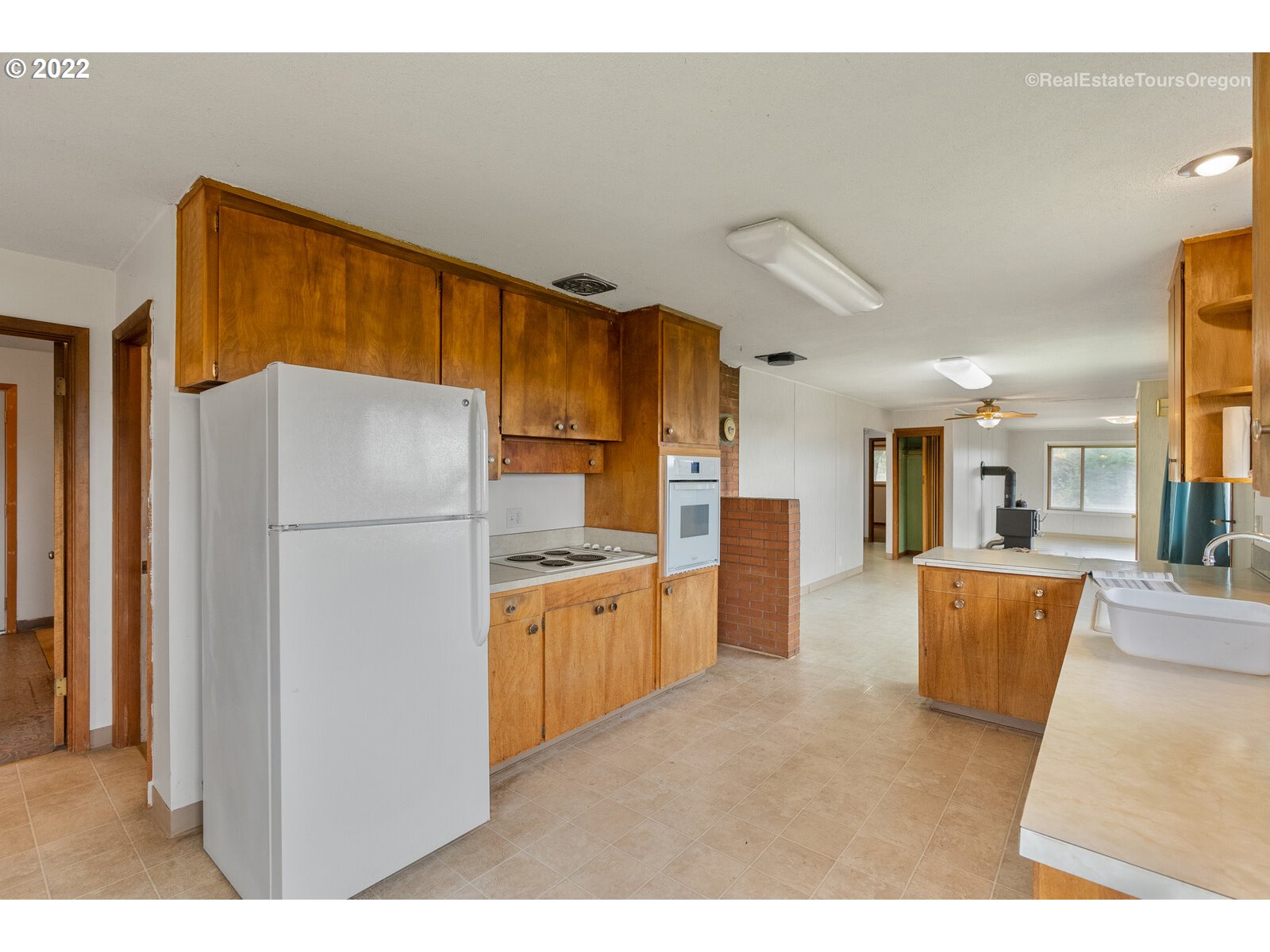 54795 Southwest Roberts School Road Gaston, OR 97119 - Photo 4 of 32 a kitchen with refrigerator cabinets and a refrigerator