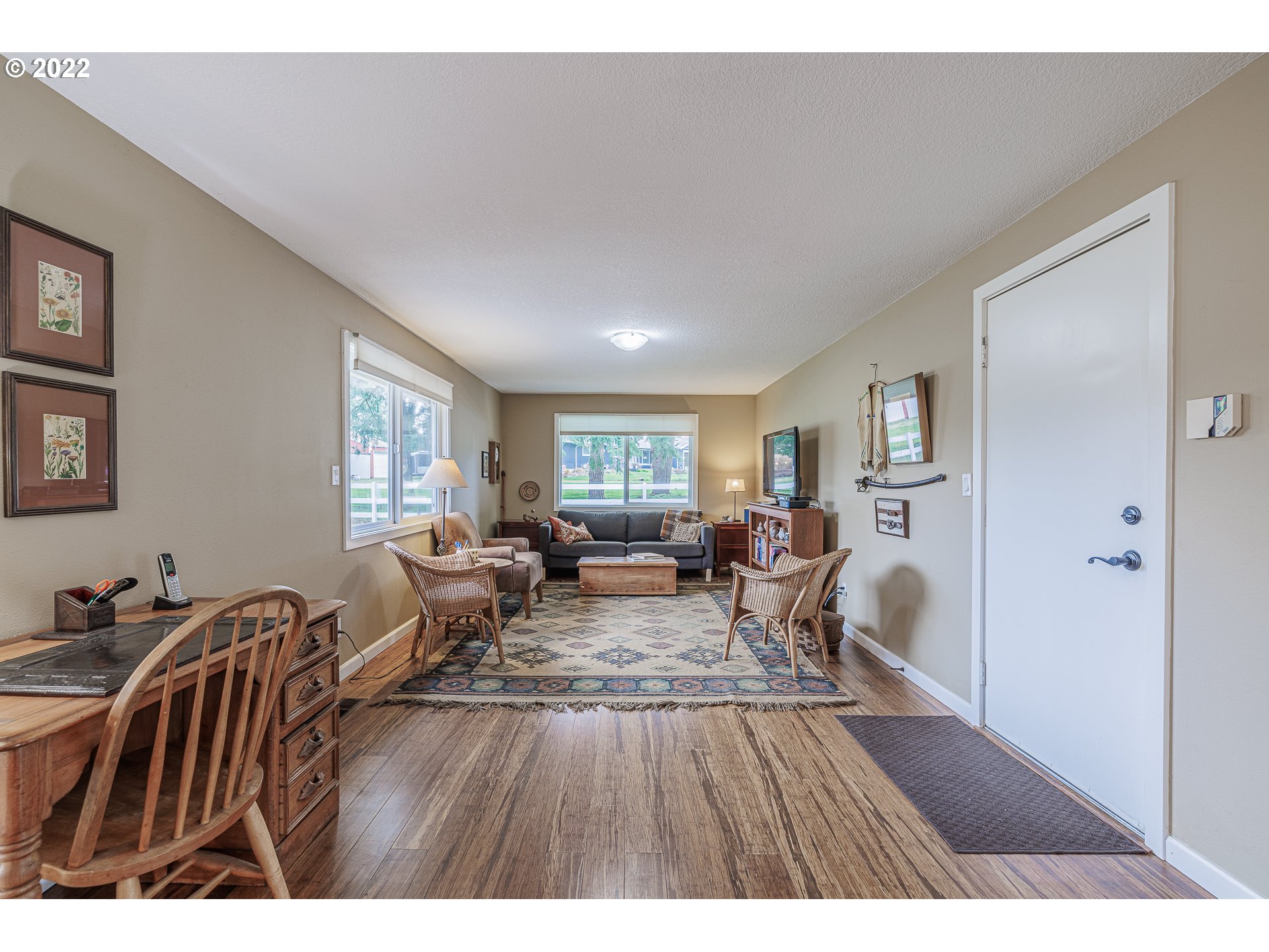 21651 Southeast Mark Road Damascus, OR 97089 - Photo 10 of 32 a living room with furniture a wooden floor and next to a window