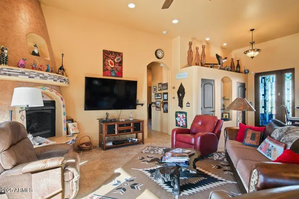a view of a kitchen with kitchen island stainless steel appliances a stove a sink a dining table and chairs