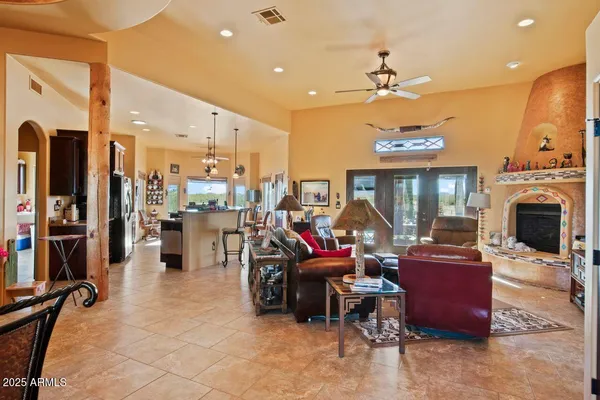 a dining room with furniture a chandelier and a large window