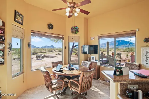 a view of a workspace with furniture and a window
