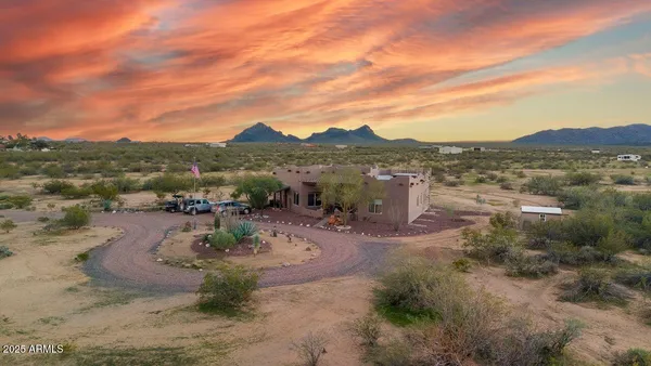 an aerial view of a house with a yard and table