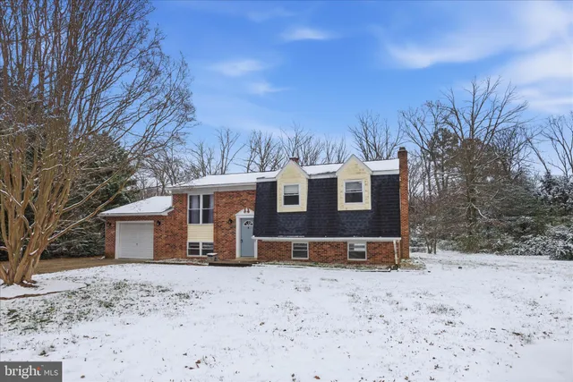 a view of a house with a yard covered with snow in the yard
