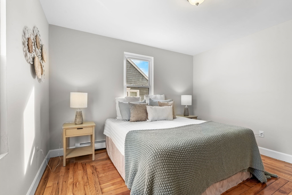 368 Read Street Somerset, MA 02726 - Photo 14 of 35 a bedroom with a bed and wooden floor