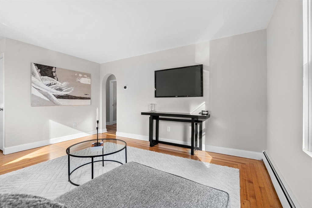 368 Read Street Somerset, MA 02726 - Photo 4 of 35 a living room with furniture a flat screen tv and a wall painting