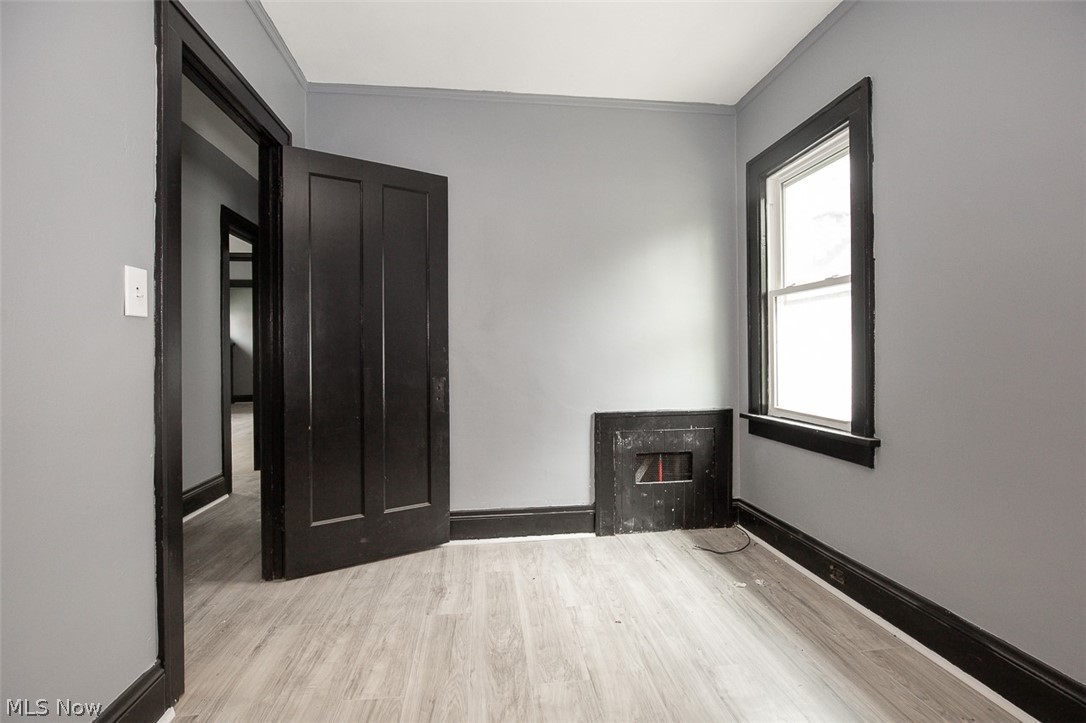 1868-1870 Lampson Road Cleveland, OH 44112 - Photo 15 of 36 Room featuring wood-finish flooring, light gray walls, and dark trim