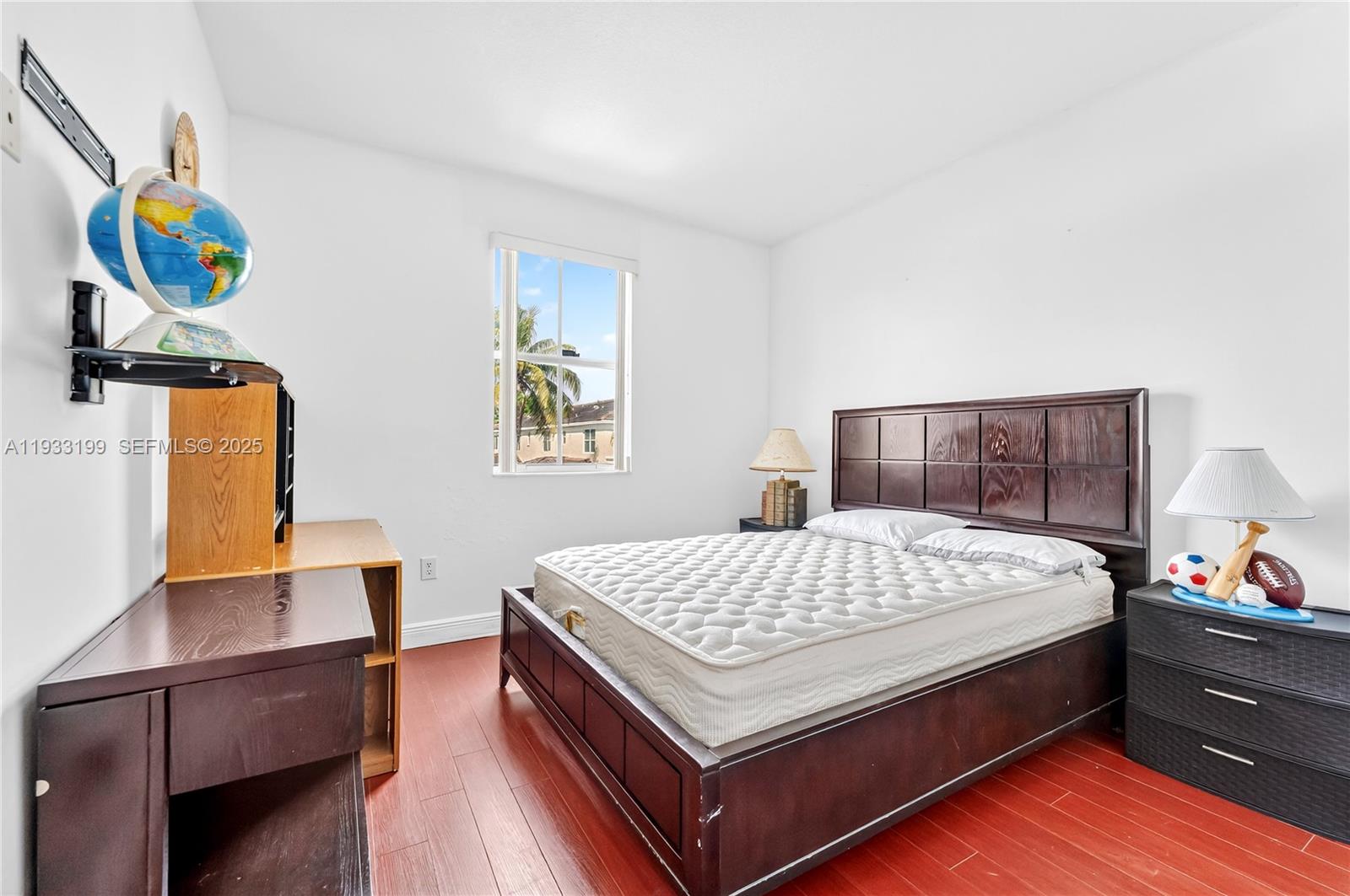 10934 Southwest 247th Terrace Homestead, FL 33032 - Photo 11 of 28 a bed sitting in a bedroom next to a window