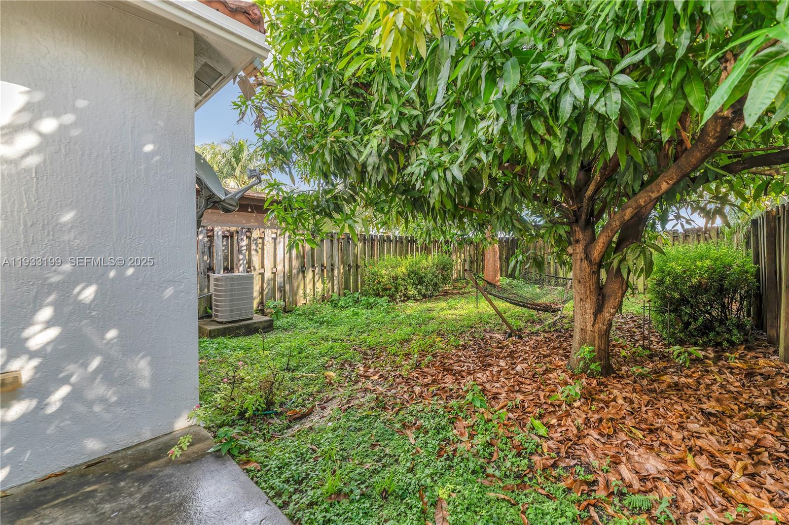 10934 Southwest 247th Terrace Homestead, FL 33032 - Photo 19 of 28 a backyard of a house with lots of green space