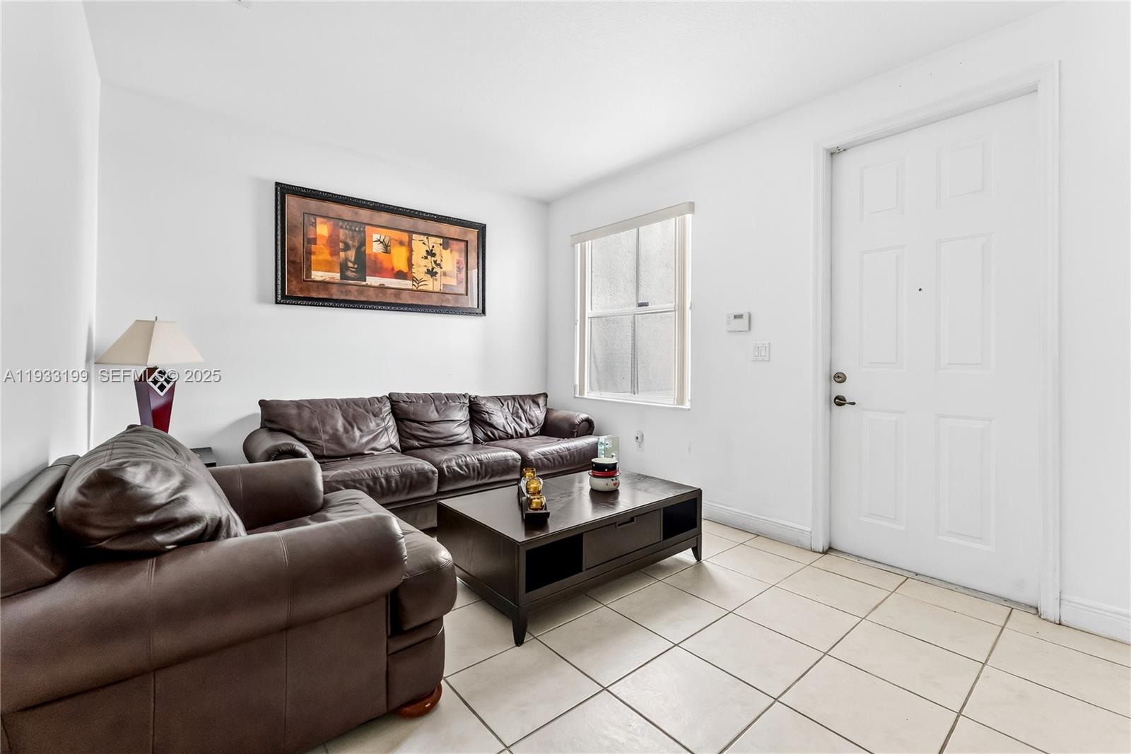 10934 Southwest 247th Terrace Homestead, FL 33032 - Photo 4 of 28 a living room with furniture and a window