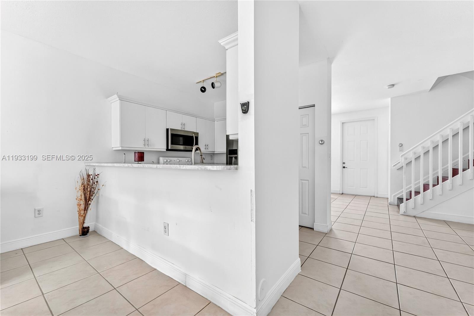 10934 Southwest 247th Terrace Homestead, FL 33032 - Photo 9 of 28 a view of a kitchen with microwave and cabinets