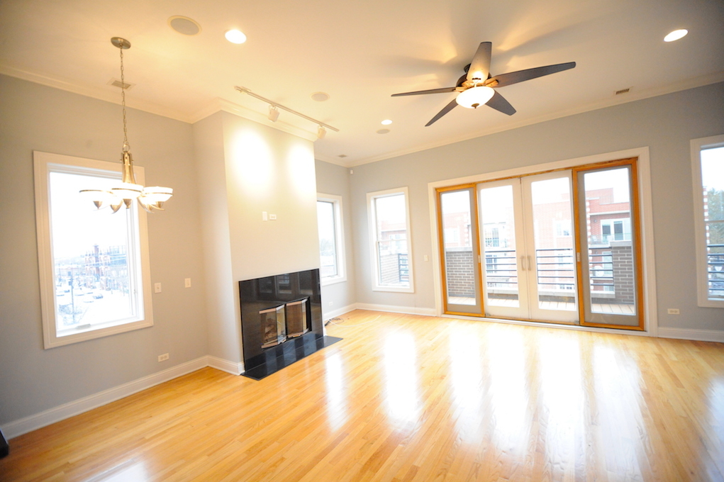 2903 West Irving Park Road, Unit 1 Chicago, IL 60618 - Photo 12 of 15 a view of an empty room with a window and kitchen view