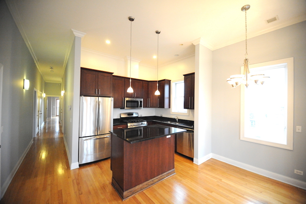 2903 West Irving Park Road, Unit 1 Chicago, IL 60618 - Photo 13 of 15 a kitchen with stainless steel appliances granite countertop a refrigerator a sink a stove and a wooden floors