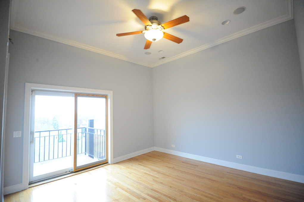 2903 West Irving Park Road, Unit 1 Chicago, IL 60618 - Photo 9 of 15 wooden floor in an empty room with a window