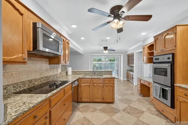a kitchen with stainless steel appliances granite countertop a stove and a sink