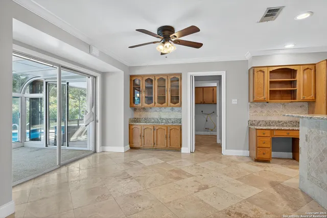 a view of an empty room with a fireplace and a window