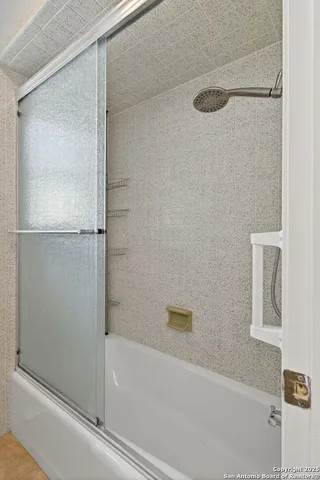 a bathroom with a bathtub and a shower