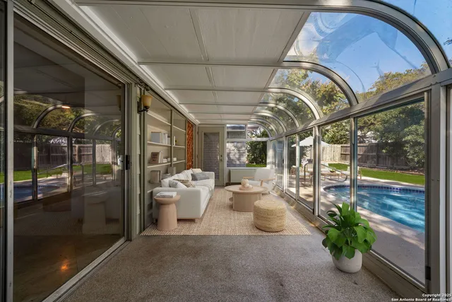 a view of a porch with furniture and floor to ceiling window