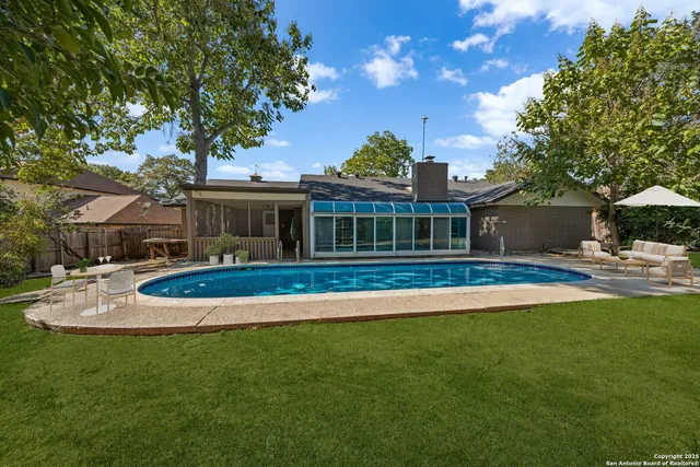 a view of house with outdoor space and garden