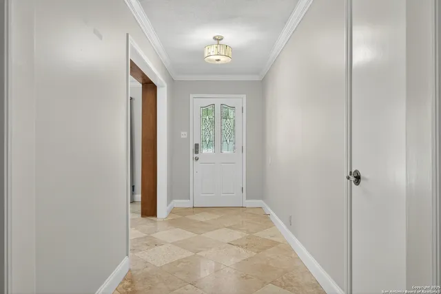 a view of a hallway with a window and a bathroom