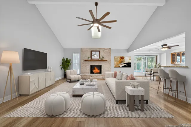 a living room with furniture a fireplace and a flat screen tv