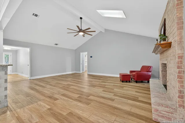 a view of a room with cabinet and a chandelier fan