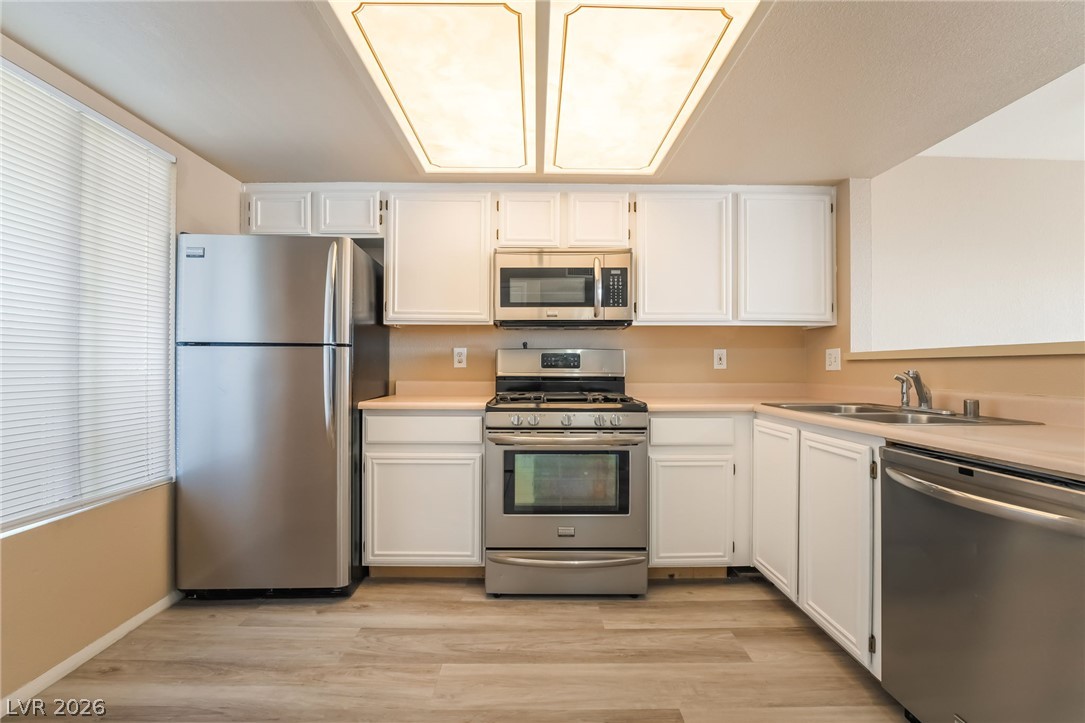 8070 West Russell Road, Unit 2024 Las Vegas, NV 89113 - Photo 7 of 19 Stainless steel appliances complement the bright white cabinetry in this well-appointed kitchen.