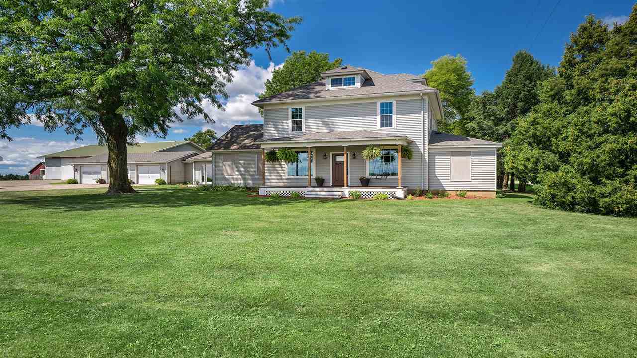 1652 South Columbian Road Oregon, IL 61061 - Photo 1 of 40 a front view of a house with garden and trees
