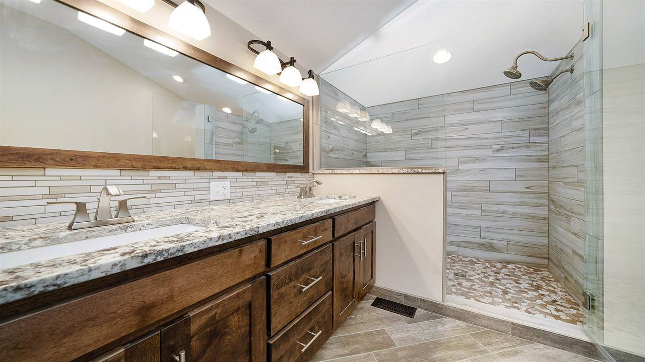 1652 South Columbian Road Oregon, IL 61061 - Photo 17 of 40 a bathroom with a granite countertop sink a vanity and shower
