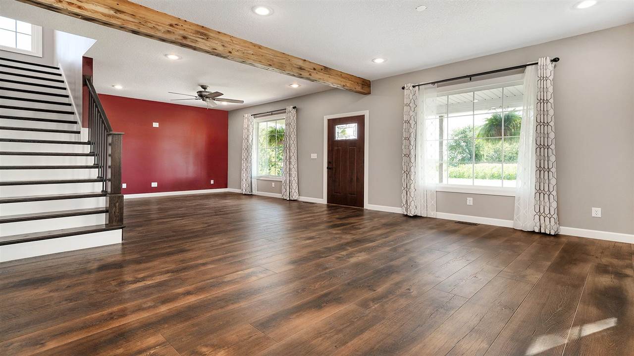 1652 South Columbian Road Oregon, IL 61061 - Photo 3 of 40 a view of an empty room with wooden floor and a window