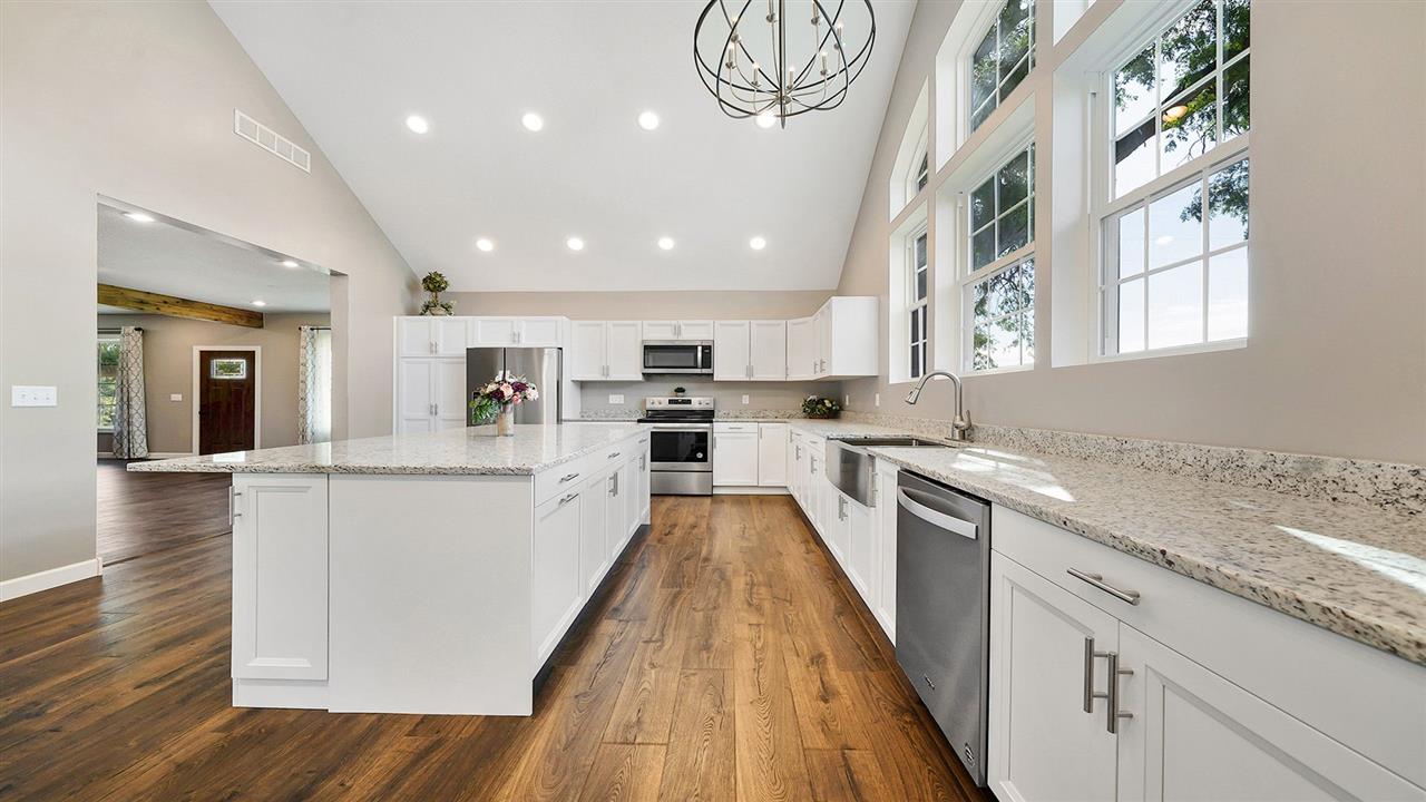 1652 South Columbian Road Oregon, IL 61061 - Photo 6 of 40 a large kitchen with stainless steel appliances granite countertop a lot of counter space and wooden floor