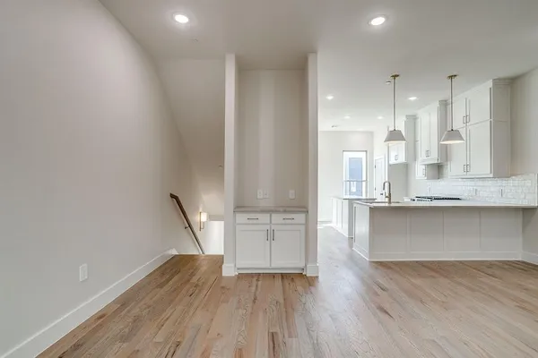a view of kitchen with wooden floor and electronic appliances