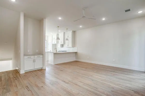 a view of kitchen with wooden floor and electronic appliances