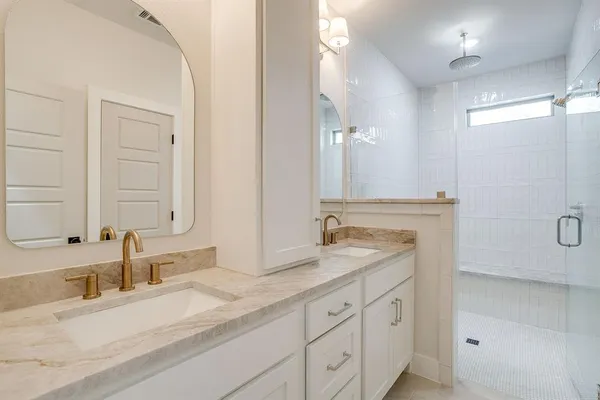 a bathroom with a granite countertop sink mirror and double