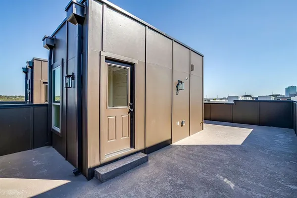 an empty room with a mirror and windows