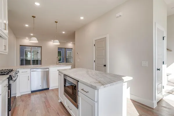 a kitchen with a stove a sink and a refrigerator