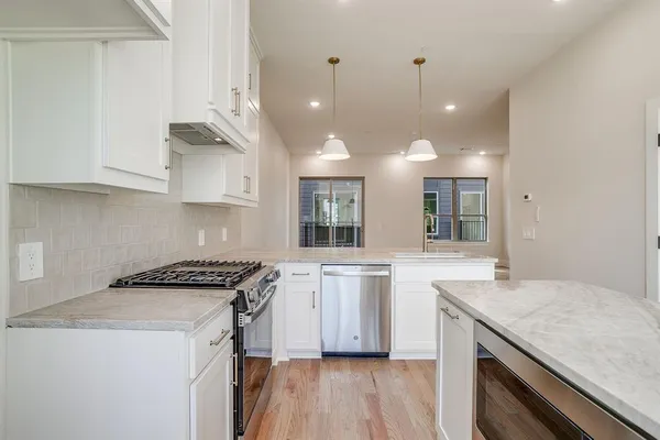 a kitchen with a sink stove and cabinets