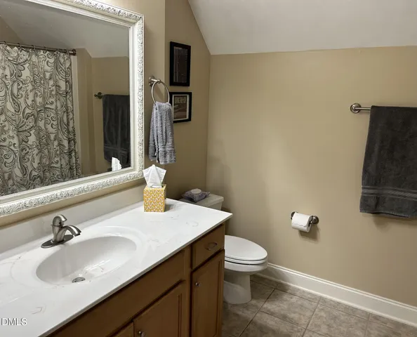 a bathroom with a sink toilet and mirror