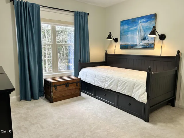 a bedroom with a bed and window