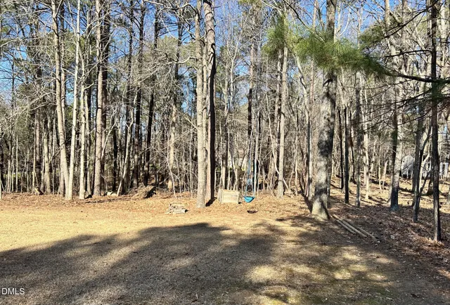 a view of wooden fence and trees