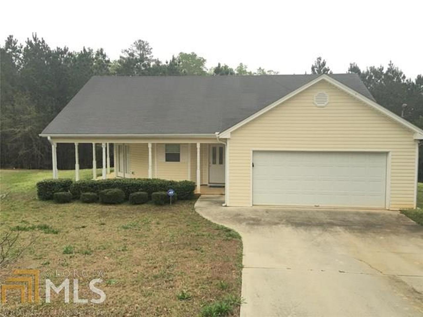 20 Spring Valley Keep Covington, GA 30016 - Photo 1 of 1 a front view of a house with a yard and garage