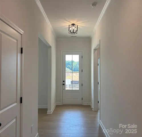 a view of an entryway with wooden floor and a window