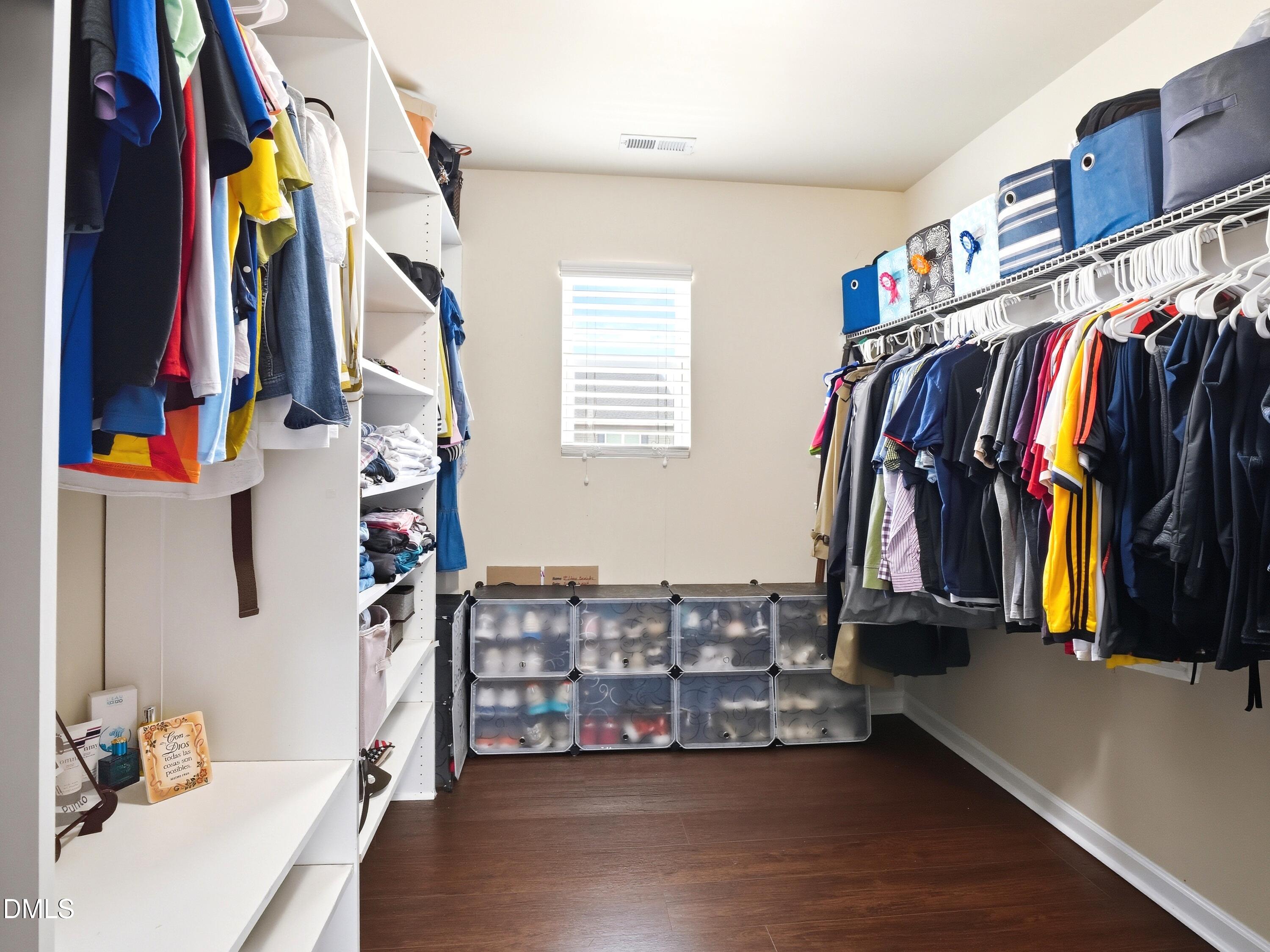 8128 Hovingham Way Raleigh, NC 27616 - Photo 17 of 40 a view of walk in closet with clothes and shoes
