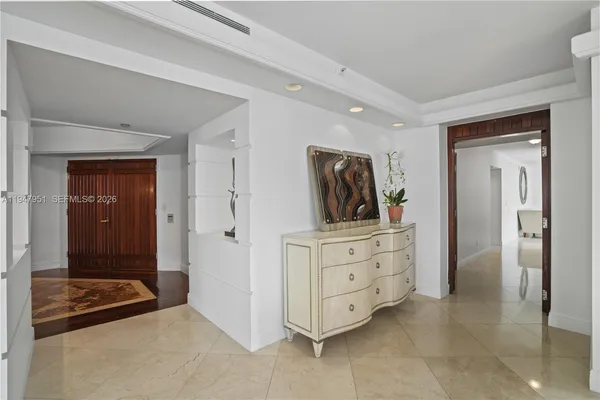 a bathroom with a granite countertop toilet sink and mirror
