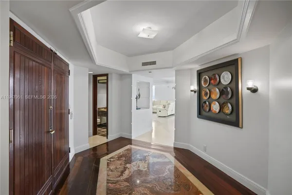 a bedroom with a bed and a dresser with mirror